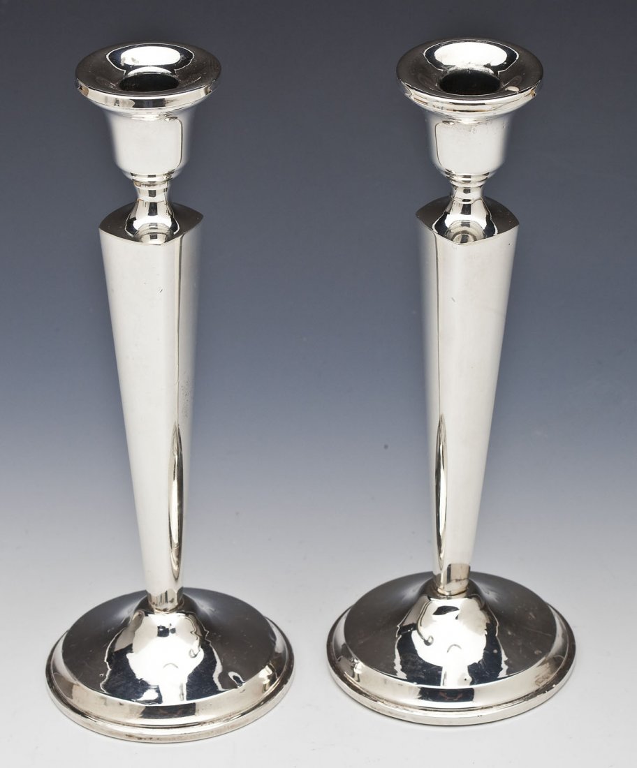 Pair of Revere Sterling Weighted Candlesticks: DESCRIPTION: Pair Revere Silversmith Inc. sterling weighted candlesticks. Style number 650. Stamped with "Revere Silversmith Inc." maker's mark and "Sterling reinforced with cement". PROVENANCE: From