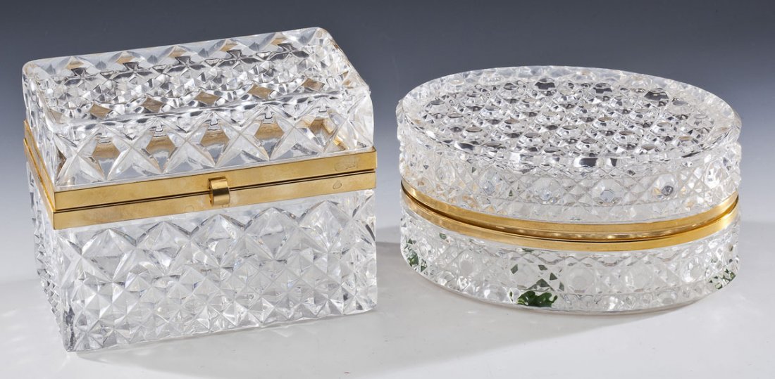 2 Cut Glass Dresser Boxes: DESCRIPTION: Two cut glass dresser boxes with brass hinges. 1) Oval. 6" x 4-1/4" x 3". 2) Rectangular with clasp at front. 5-2/8" x 3-1/4" x 4-1/8". MEASUREMENTS: See Description. CONDITION: Oval box 