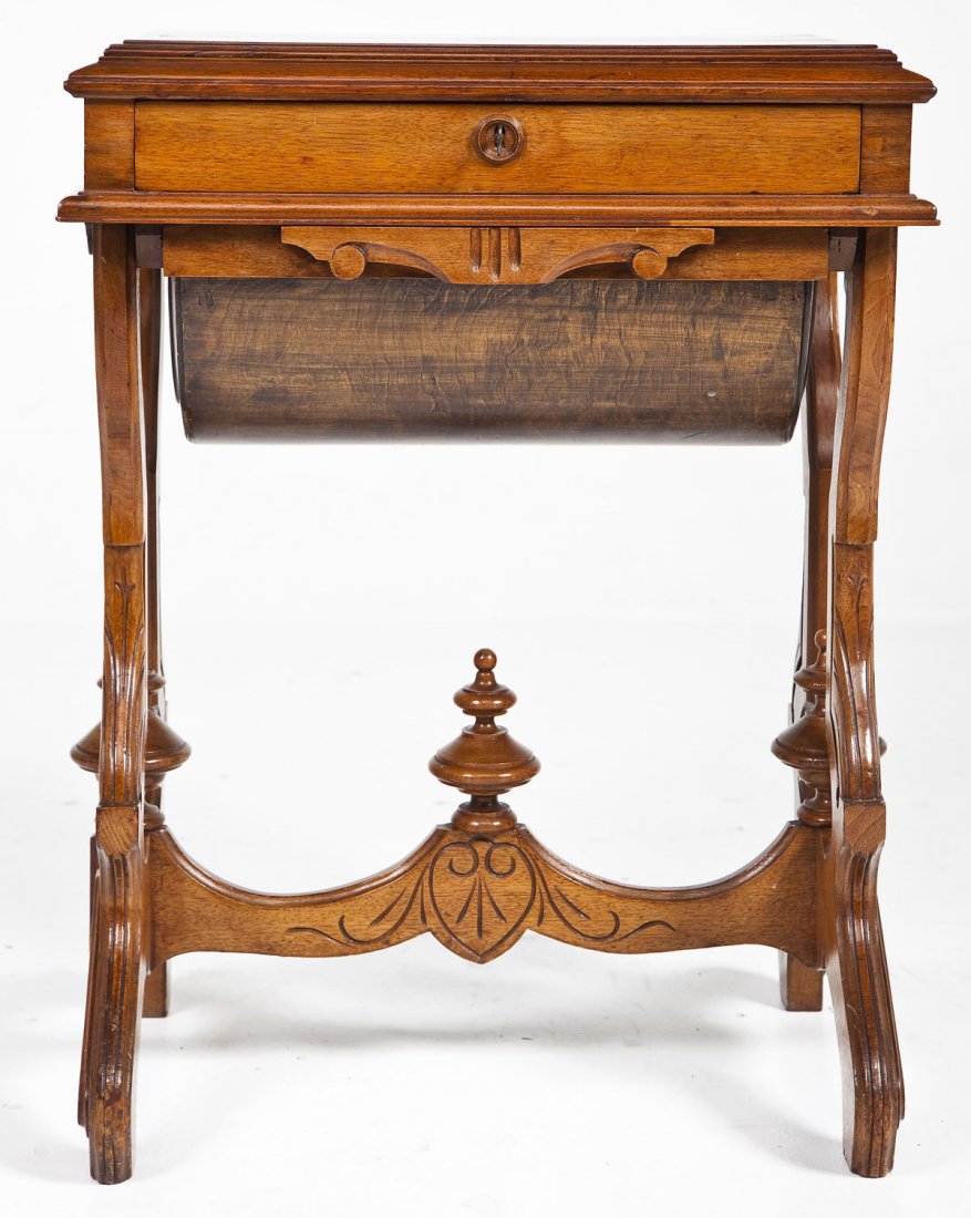 Victorian Sewing Table: DESCRIPTION: A Victorian Renaissance Revival sewing table, probably walnut and American made, circa 1880-90. The form consisting of scroll legs and stretchers (with surmounting turned elements) suppor