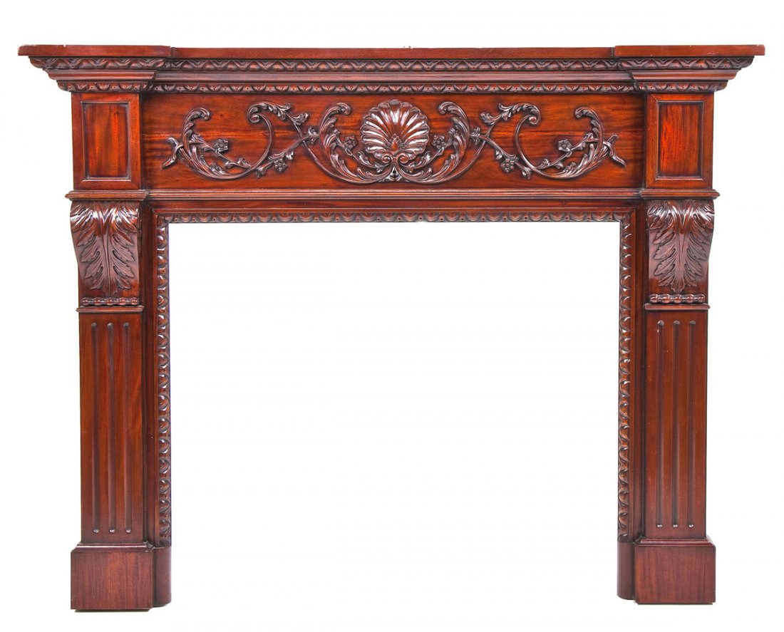 A Cherry Colonial Revival Mantle and Surround: DESCRIPTION: A very fine and highly carved cherry Colonial Revival mantle and surround possibly by Slaugh of Lancaster, Pennsylvania. The mantle with heavy supporting pilasters terminating in acanthus