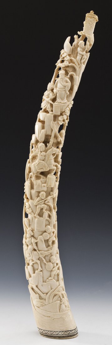 Carved Ivory Tusk: DESCRIPTION: Carved ivory tusk depicting battle scene. Decoration includes figures wielding weapons and on horseback. Cartouche seal on base. MEASUREMENTS: 22" long at base x 2-3/4" across at widest p