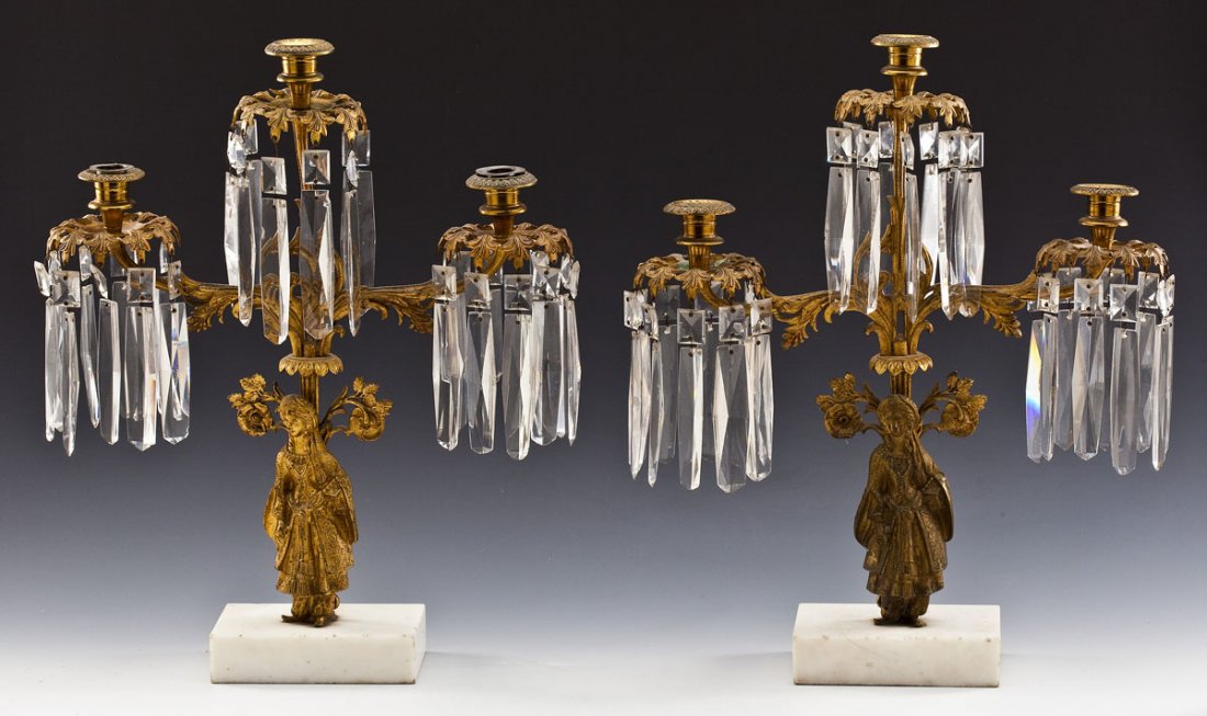Pair Brass and Marble Figural Candelabras: DESCRIPTION: Pair of brass and marble based figural candelabras. Figures of women in middle eastern dress. Each with three lights and prisms hanging from them. Arms in a leaf and scroll motif. MEASURE