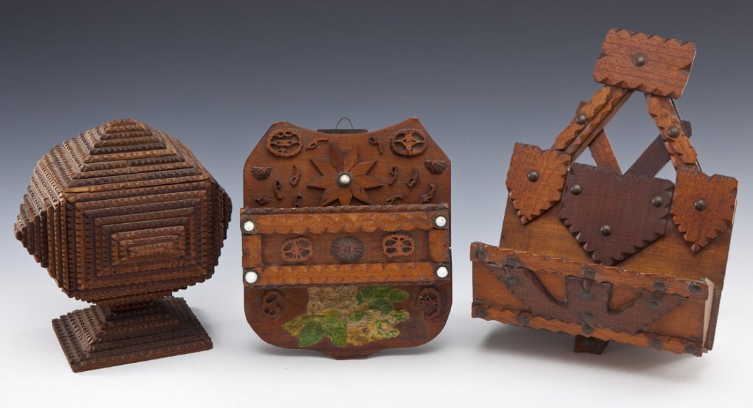 3 Pieces of Tramp Art: DESCRIPTION: Three pieces of tramp art. Includes: 1) 7" x 8" x 9" high chip carved box with lid in pyramidal shapes. 2) 8" x 9" x 3-1/8" deep wall mounted holder with cross-sections of walnut shells a