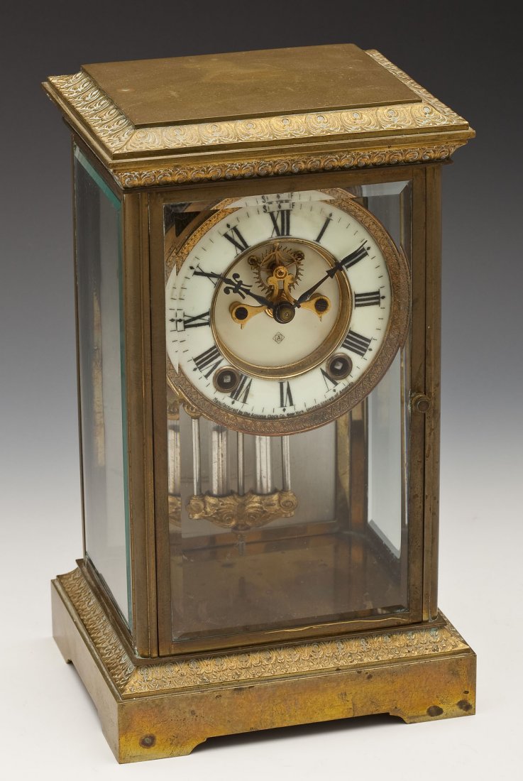 Ansonia Crystal Regulator: DESCRIPTION: Crystal regulator by Ansonia. Brass case with beveled glass. Enameled porcelain dial with Arabic numerals and outside escapement, marked "Manufactured by the Ansonia Clock Co. New York Un