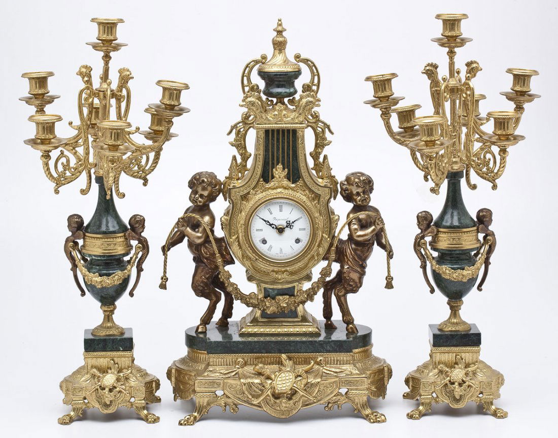 Brevettato Gilt Brass and Marble Garniture Set: DESCRIPTION: Italian Brevettato gilt bronze garniture set. Includes: 1) Pair of 24-1/4" high green marble and gilt bronze 7 light candelabras. Two cherubs on either side with swags between. Four claw