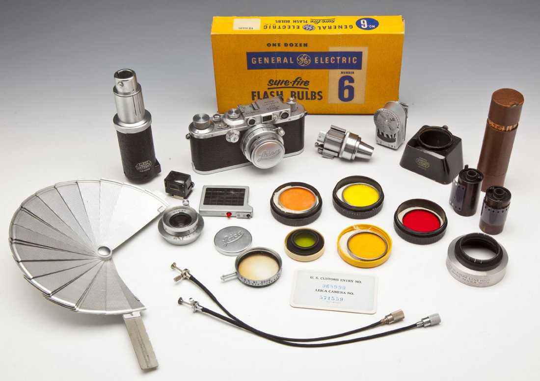 Leica IIIa Camera with Accessories & Lenses: DESCRIPTION: A Leica IIIa 35mm rangefinder camera, serial number 188015, with a Summar f=5cm 1:2 lens No. 282111. Circa 1936. Also includes: 1) Leica Hektor f=2.8cm 1:6.3 lens in original case 2) Leic