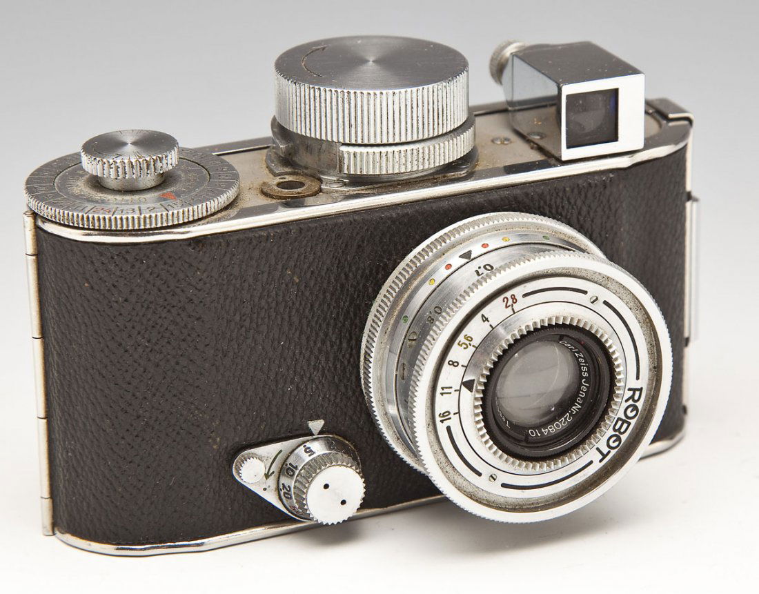 German Robot Camera: DESCRIPTION: German Robot 35mm camera by the Otto Berning & Co., Schwelm-Weste. With Carl Zeiss Jena Tessar 1:28 f=3-3/4cm lens. MEASUREMENTS: 4-1/4" x 2-1/2". CONDITION: Minor overall wear. Some soil