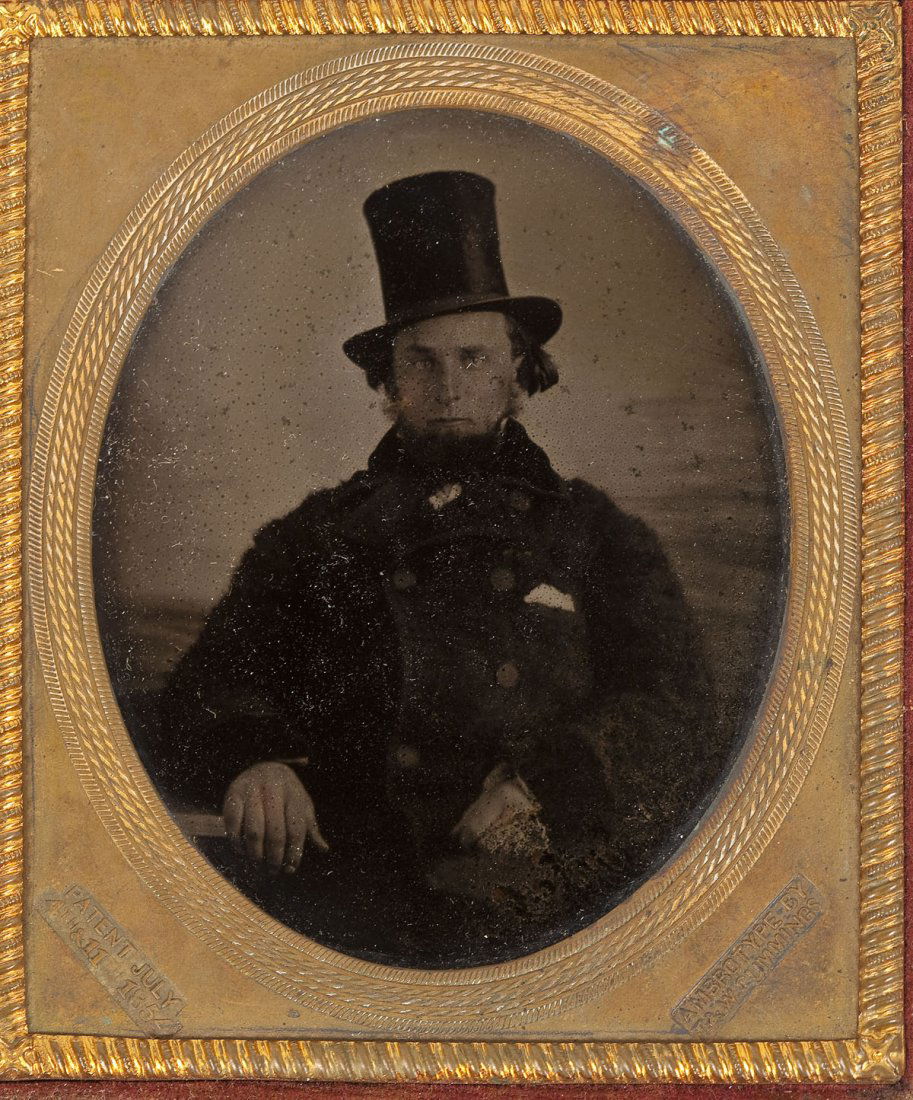 Cased Ambrotype of Man in Top Hat: DESCRIPTION: Sixth plate ambrotype of a bearded man with coat and top hat. Brass mat marked for T. & W. Cummings with patent date of July 4th & 11th, 1854. MEASUREMENTS: Overall with case 3-7/8" x 3-1