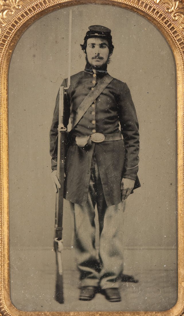 Ambrotype of a Civil War Soldier: DESCRIPTION: Ambrotype of a Civil War soldier with service musket with affixed bayonet. Stamped brass protector and mat. MEASUREMENTS: Overall with case 3-7/8" x 2-1/2". CONDITION: Image clear and str