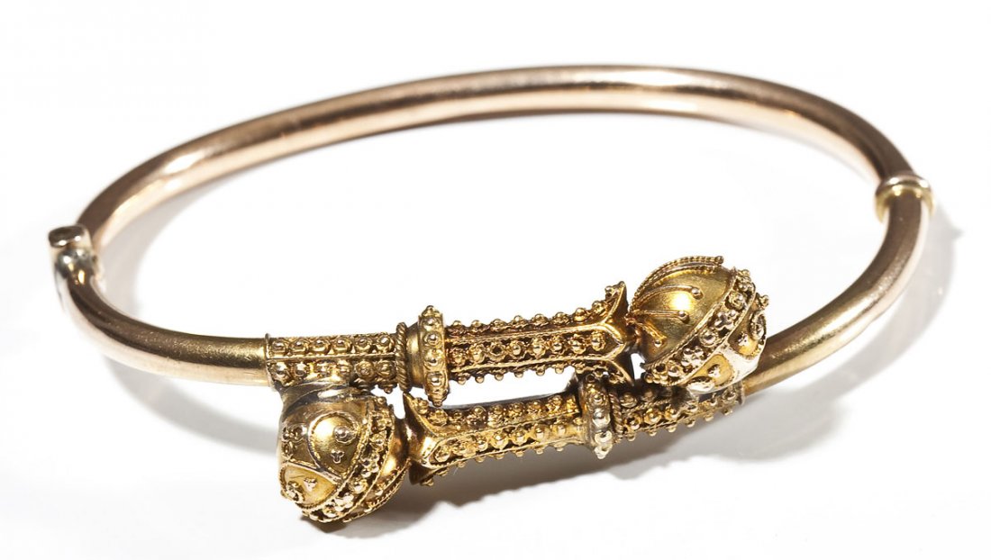 Victorian 14K Hollow Hinged Bangle: DESCRIPTION: Victorian bangle in tested 14K yellow gold with two ornamental scepters in bypass formation. MEASUREMENTS: Opening 2-1/8" x 1-5/8". 6.5 dwt (10.1 gr). CONDITION: No defects noted.