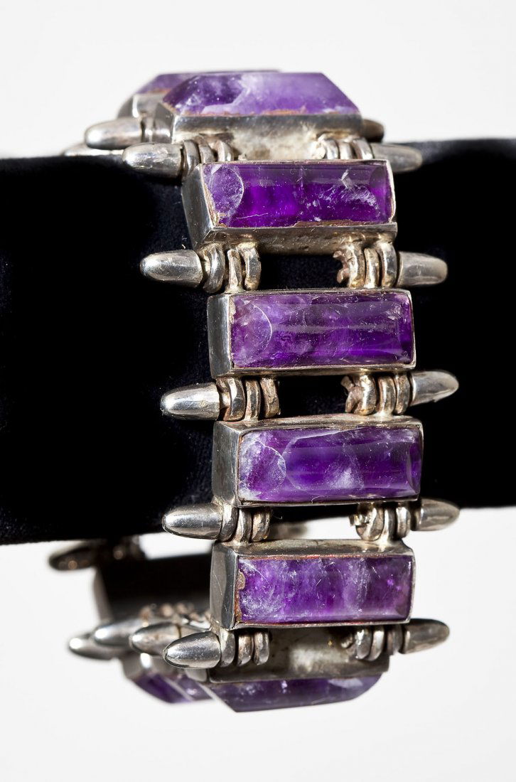 Antonio Pineda Taxco Sterling & Amethyst Bracelet: DESCRIPTION: Taxco Mexican sterling bracelet of twelve oblong cabochon amethyst gemstones. Marked with signature of Antonio Pineda in a crown. Pineda was a well-known silversmith in the 1940s and beca