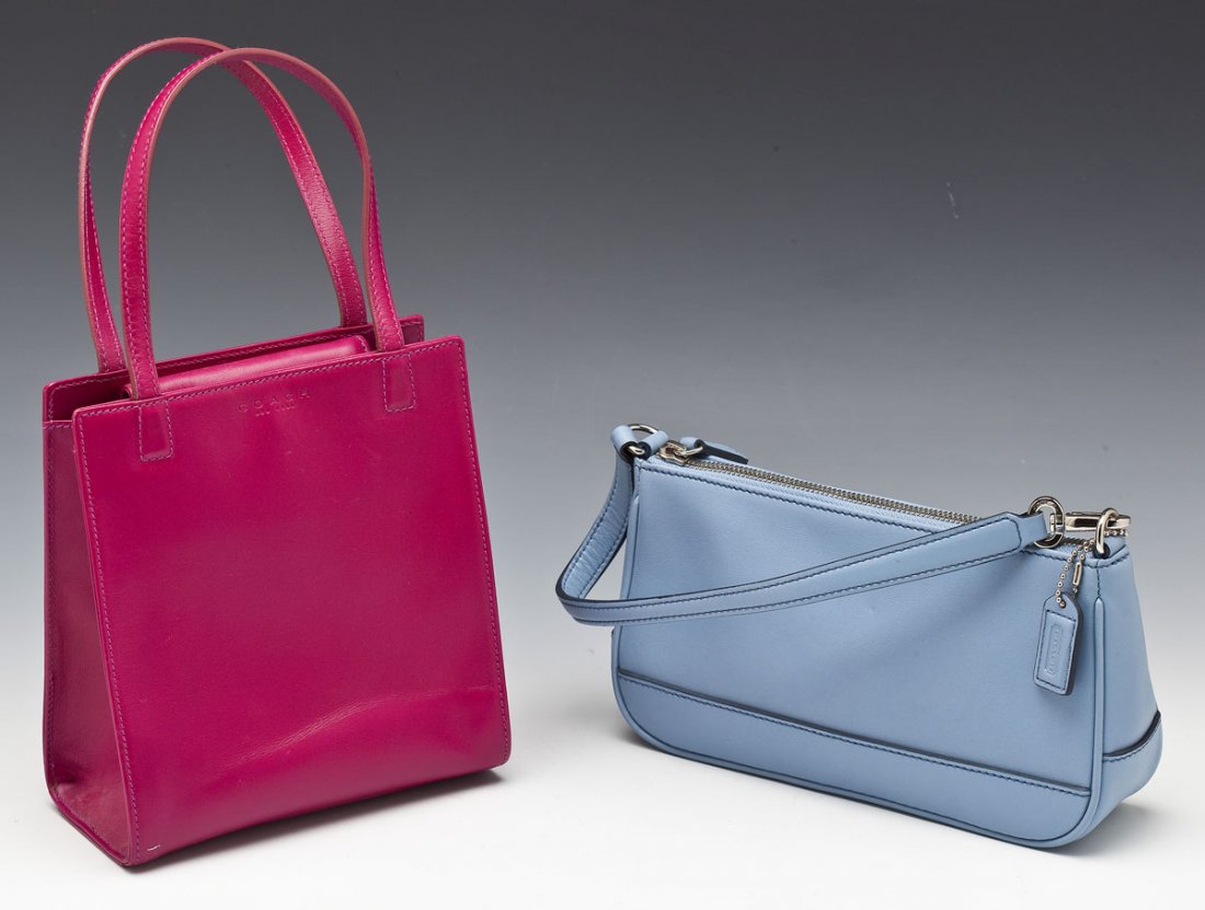 2 Coach Small Leather Handbags: DESCRIPTION: Two Coach small leather handbags. Includes: 1) Magenta pink square handbag with magnetic enclosure, black lining and interior zippered pocket. 2) Sky blue rectangular handbag with zipper 