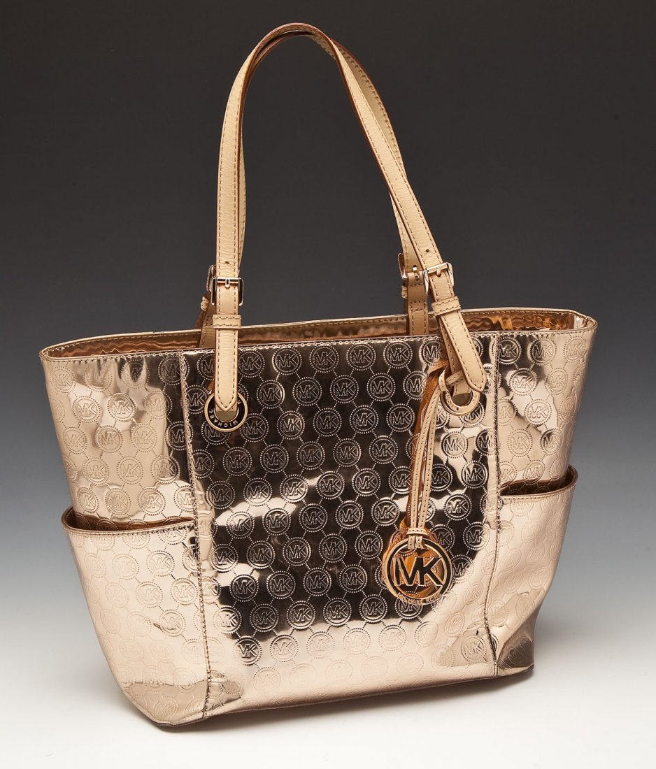 Michael Kors Metallic Shoulderbag: DESCRIPTION: Warm-toned metallic shoulderbag by Michael Kors with emblem stamped into the material. Large interior zippered pocket plus smaller compartments on interior. Gold lining and gold accents. 