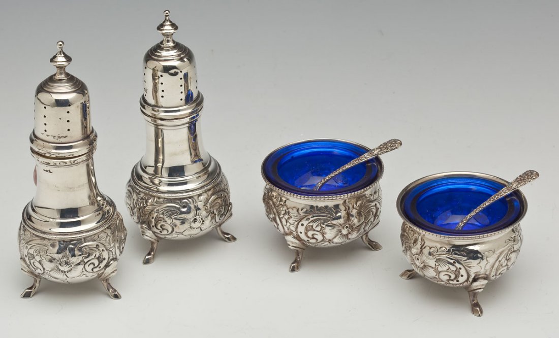 Pair of Sterling Repousse Shakers & Salt Cups: DESCRIPTION: Pair of sterling silver footed repousse pepper shakers and footed salt cups with repousse salt spoons marked "S. Kirk & Son Sterling". Cups have cobalt glass liners. Cups marked "NES Ster