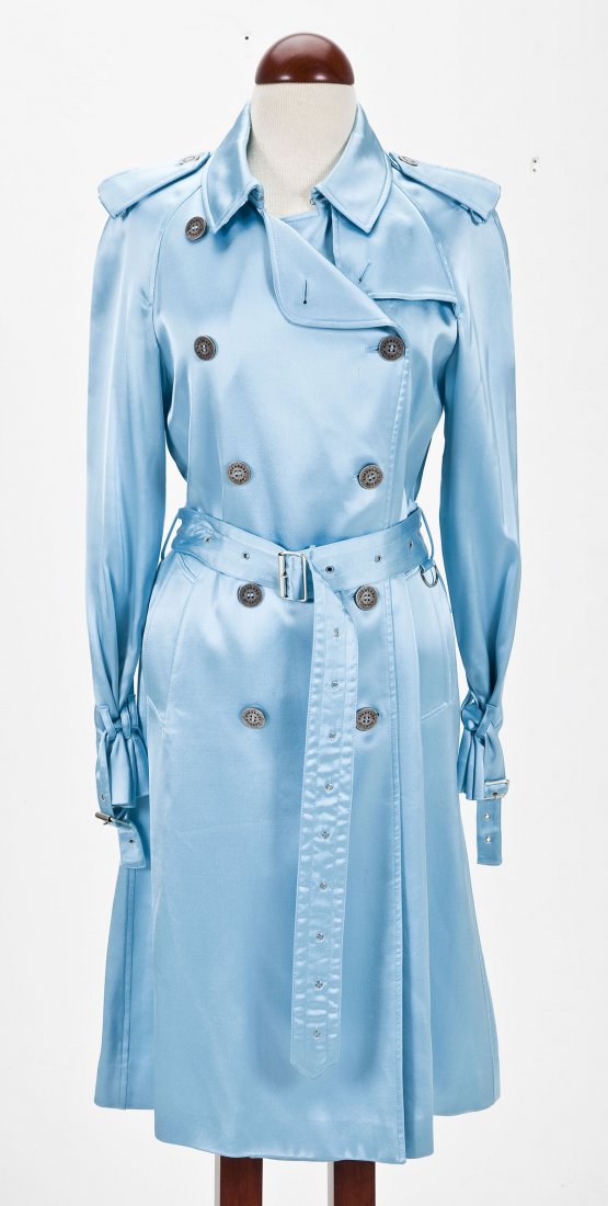 Blue Burberry Trench Coat: DESCRIPTION: Metallic sky blue viscose double-breasted trench coat by Burberry. With attached self-belt and adjustable cuffs. Metallic buttons. MEASUREMENTS: UK size 12 (US size 10). CONDITION: Light