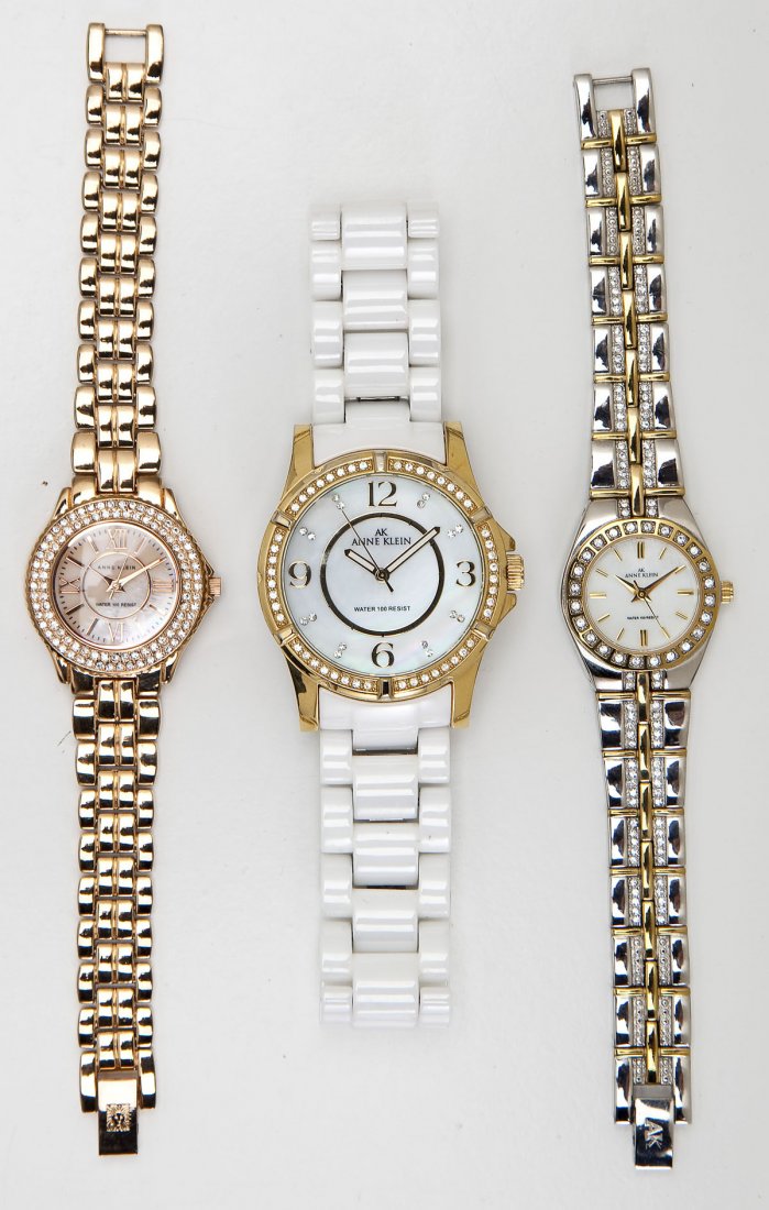3 Anne Klein Fashion Wristwatches: DESCRIPTION: Three Anne Klein fashion wristwatches with mother of pearl dials and rhinestones. All water resistent. MEASUREMENTS: From 1-1/4" to 1-7/8" lug to lug. CONDITION: No defects noted.