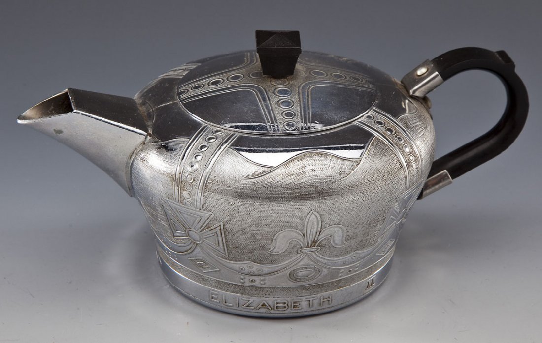Elizabeth II 1953 Coronation Teapot: DESCRIPTION: Queen Elizabeth II 1953 coronation metal teapot. Stamped to bottom "Swan Brand, Swan-Comalin, Made in England" and decorated to exterior and lid. MEASUREMENTS: 7-1/2" x 3-1/2" high. CONDI