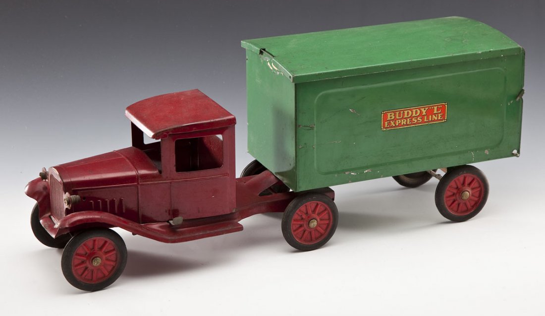 Buddy L Express Line Truck: DESCRIPTION: Buddy L Express Line two piece pressed steel truck. Red enclosed cab, green box van body with removable roof, fold-down tailgate, embossed rubber wheels. Circa 1934. MEASUREMENTS: 23" lon