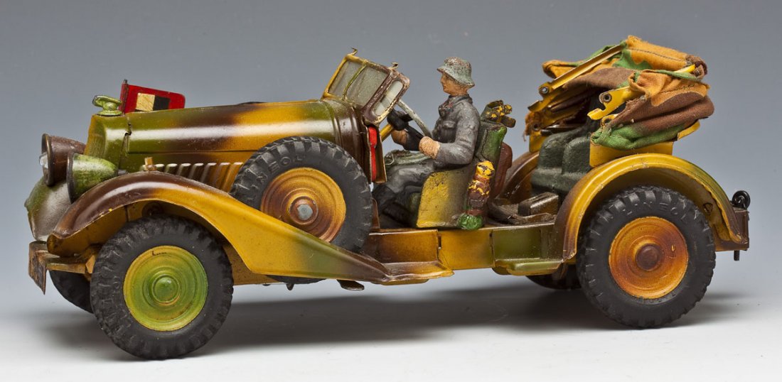 Lineol German Tinplate Staff Car (Kuebelwagen): DESCRIPTION: Lineol German tinplate Staff Car (Kuebelwagen), complete with flag, retractable cloth top, electrified headlights and battery compartment underneath chassis. One Luftwaffe toy soldier dri