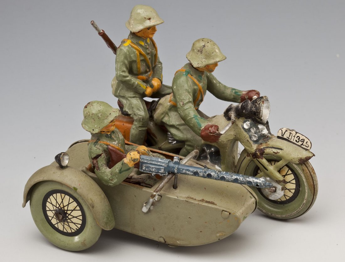 Hausser-Elastolin Swiss Army Motorcycle & Sidecar: DESCRIPTION: Prewar Germany circa 1930's, all original and intact with correct accessories. Non-clockwork version. Cycle and sidecar tin, figures composition. CONDITION: Very minor paint chips on cycl