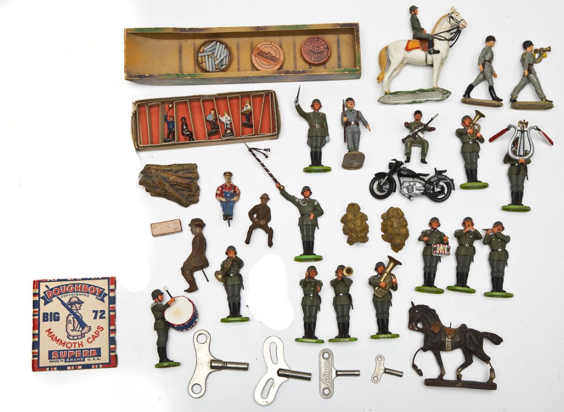 Misc Lot of Plastic Elastolin Soldiers & Vehicles: DESCRIPTION: Approximately thirty pieces, consisting of plastic post-war Elastolin Germany Army Band figures, motorcyclist, original wooden Lineol pontoon, various small boxes of pre-war caps, origina