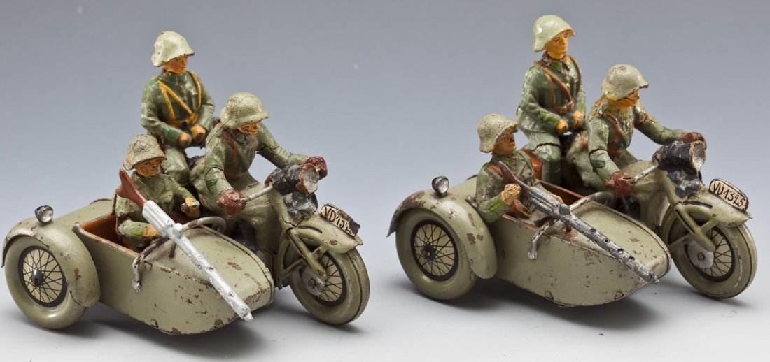 Hausser-Elastolin Swiss Army Motorcycle & Sidecars: DESCRIPTION: Two Swiss Army motorcycles and sidecars, both with intact tin sidecars and motorcycles and complete composition crews. Crew members in various states of preservation, each with some corro