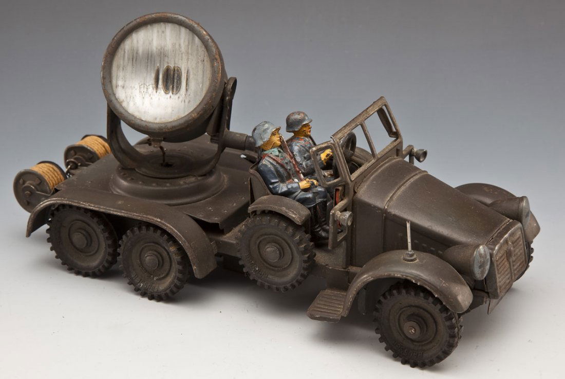 Hausser-Elastolin Searchlight Truck: DESCRIPTION: Pressed lithographed and painted tin, original rubber tires, working clockwork (one control lever possibly missing) with two original composition Luftwaffe (German Air Force) crew. Elevat