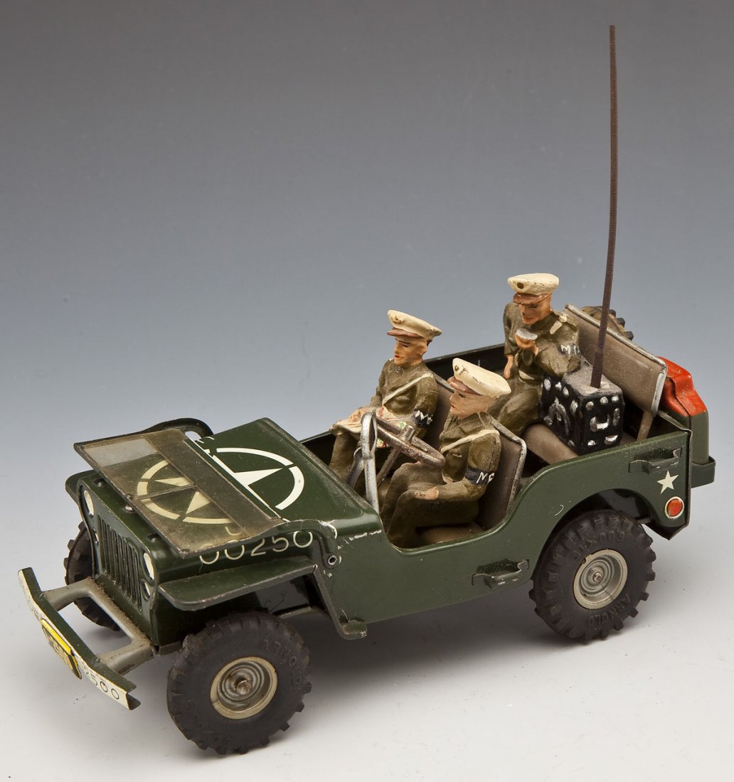 Arnold No. 2400 U.S. Army Military Police Jeep: DESCRIPTION: Consists of Jeep, pressed lithographed tin, rubber tires, intact clockwork with key, and three composition U.S. MPs with radio. Complete in all ways, a superb example of this postwar toy 