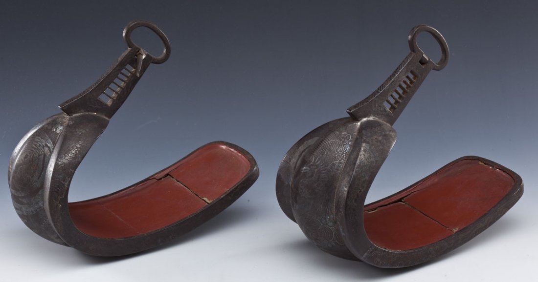 Pr Japanese Inlaid Iron Stirrups (Abumi): DESCRIPTION: Pair of Japanese stirrups or abumi of iron inlaid in silver with design of birds and flowers over a basketweave underneath. Red lacquered interior. Probably Edo period. MEASUREMENTS: Each