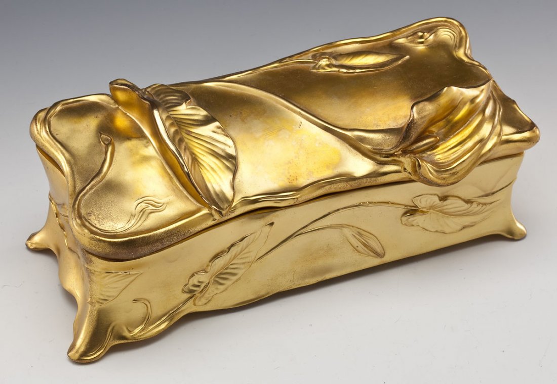 Benedict Art Nouveau Gilt Metal Dresser Box: DESCRIPTION: Benedict Art Nouveau gilt metal dresser box. Lily and leaf motif throughout. Blue fabric liner. Marked underneath "Benedict", Benedict maker's mark (for Benedict Mfg. Co., East Syracuse, 