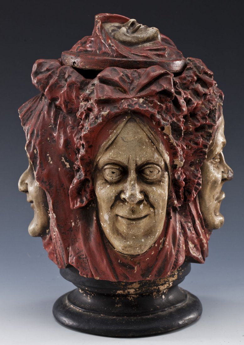 Plaster Four Faces Jar: DESCRIPTION: Unusual vintage plaster or composition jar in the form of four faces in various expressions on a black pedestal base. Figural lid with similar face. MEASUREMENTS: 11-1/2" high. CONDITION: