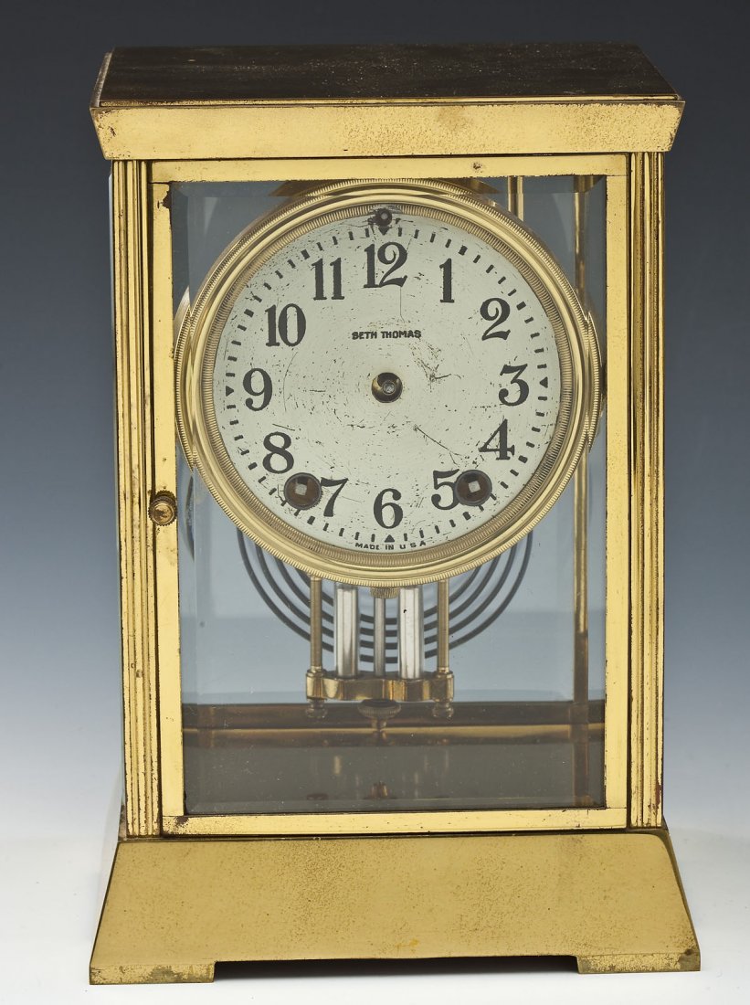 Seth Thomas Crystal Regulator: DESCRIPTION: Seth Thomas crystal regulator. Brass case with beveled glass inserts. Silvered dial marked "Seth Thomas Made in USA". Brass movement marked "48S" with Seth Thomas logo. Includes mercury p