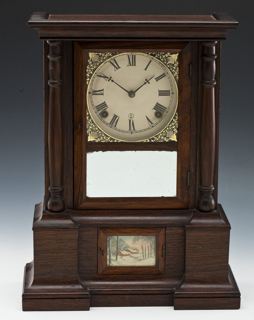Seth Thomas 30 Hour Mantle Clock: DESCRIPTION: Seth Thomas mantle clock. Oak case with top cornice and side columns. Paper dial behind reverse painted glass with mirrored tablet. Lower small door with landscape print. Original label t