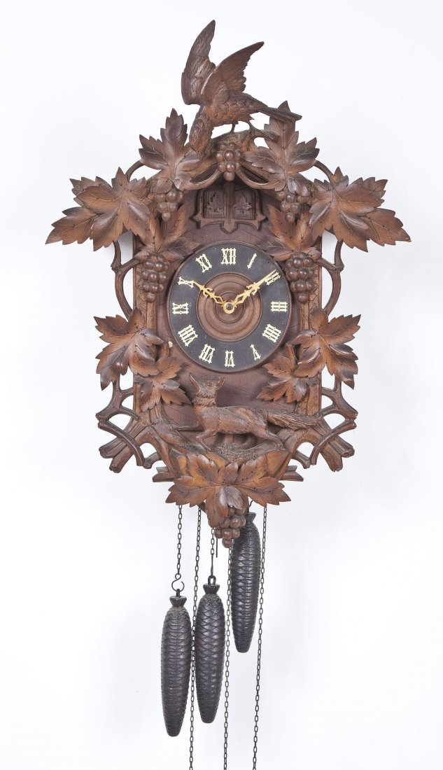 Black Forest Cuckoo Clock: DESCRIPTION: Black Forest cuckoo clock. Heavily hand carved with bird, grapes and fox. Three weights, two cuckoos. Interior door stamped "July 29, 1912". Brass works stamped "GK". MEASUREMENTS: 28" lo