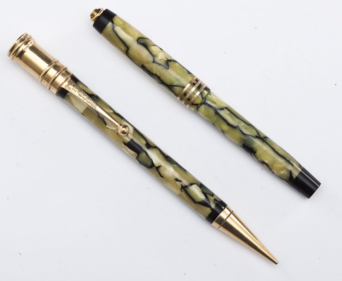 Parker Duofold Fountain Pen & Pencil: DESCRIPTION: Parker Duofold 4-1/2" fountain pen in light green and black pearl with Parker Duofold Deluxe nib. Together with a matching 5-1/2" mechanical pencil. MEASUREMENTS: See Description. CONDITI