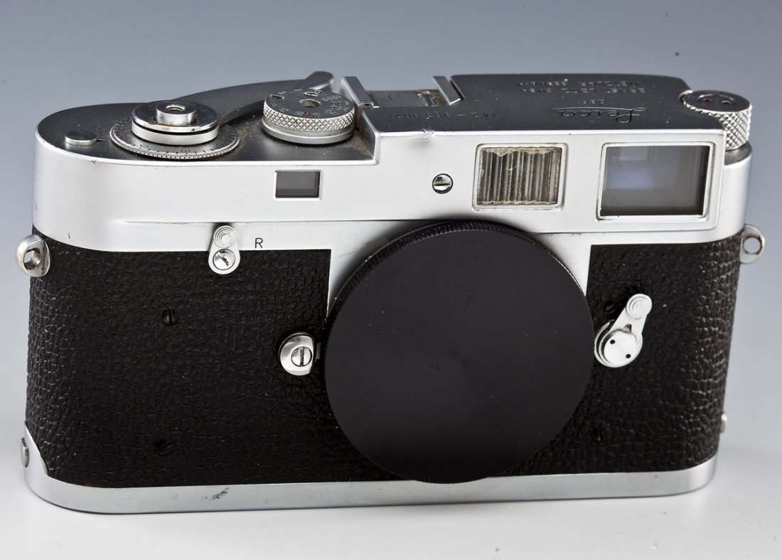 Leica M2 Camera Body: DESCRIPTION: Leica M2 camera body serial #983807, marked "Leica DBP Ernst Leitz GMBH Wetzlar Germany". Circa 1959. MEASUREMENTS: 5-1/2" wide. CONDITION: Working condition. Small ding to top front edge