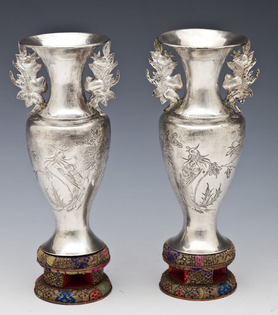 Pair Chinese Export Silver Vases: DESCRIPTION: Pair of Chinese silver vases on embroidered bases. Vases with etched floral and bird motifs. Each with two floral and fruit handles. Each marked underneath with Chinese hallmarks. MEASURE