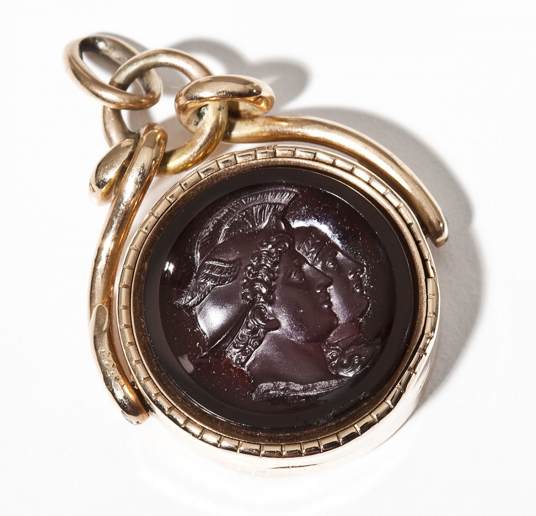 Edwardian Reversible Soldier Cameo Locket: DESCRIPTION: Edwardian goldfilled cameo locket. One side with double soldier cameo. The other side monogrammed "D". Interior locket with lock of hair. MEASUREMENTS: 1-5/8" long. CONDITION: Minor wear.