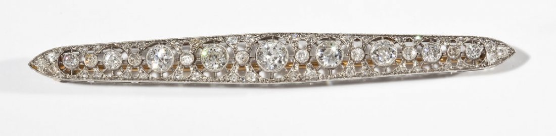 3.21 CTW Diamond Filigree Bar Pin: DESCRIPTION: Diamond filigree bar pin in platinum with yellow gold hinge catch and pin stem. Set with sixty-three Old European and Old Mine cut diamonds (one .60 carat, four .34 carat, two .11 carat, 