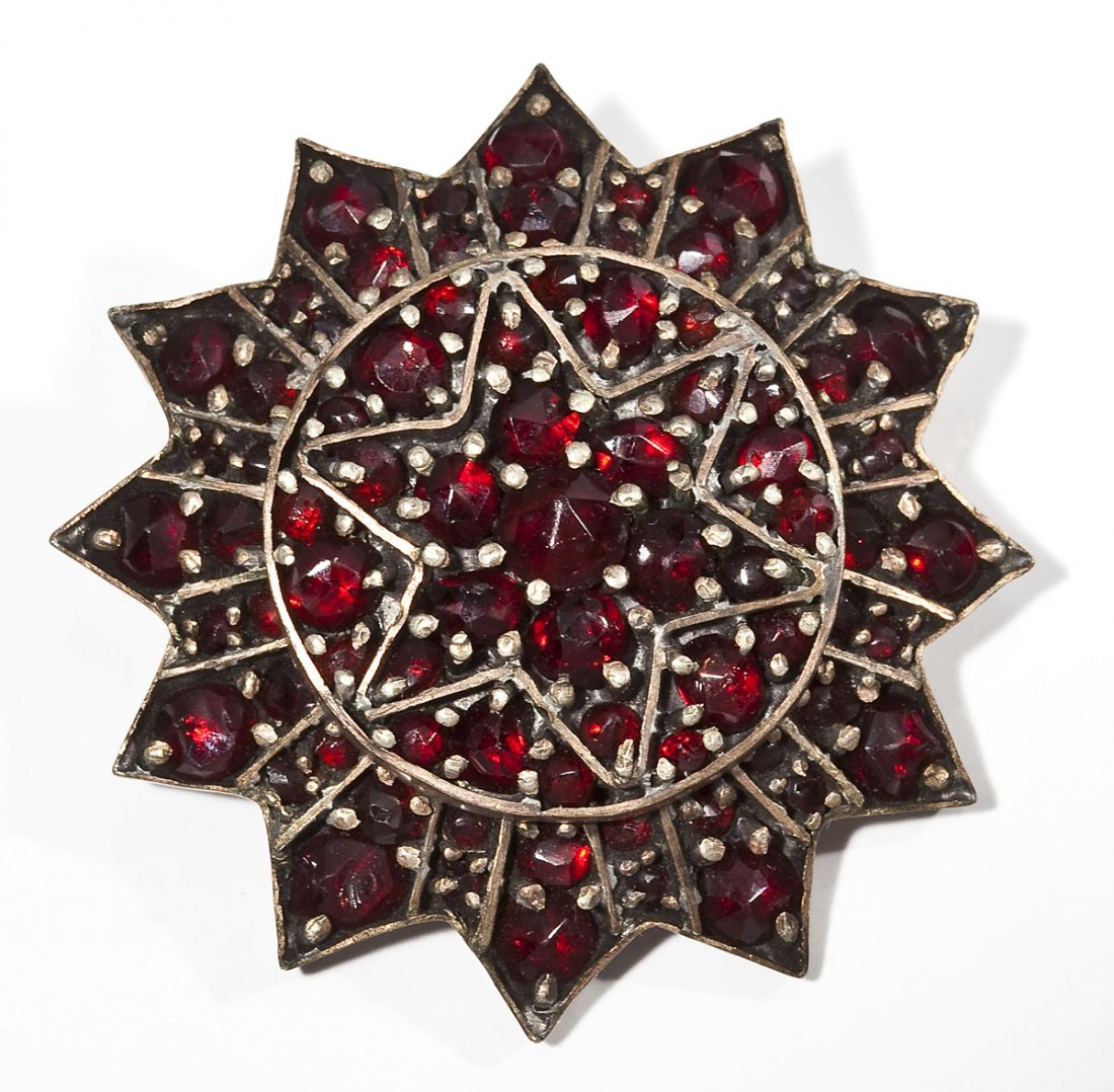 Bohemian Garnet Cluster Brooch: DESCRIPTION: Victorian sunburst shaped Bohemian garnet cluster pendant with six pointed star in the center. MEASUREMENTS: 1-1/2" diameter. CONDITION: Minor wear.