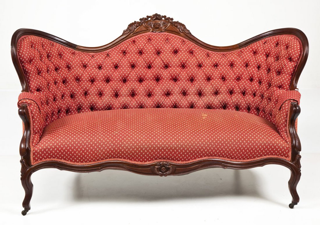 Victorian Rococo Revival Settee: DESCRIPTION: A Victorian (circa 1860-80) Rococo revival settee consisting of four curved French cabriole legs rising to a curved frame with finely carved rose crest. The settee body with overstuffed u