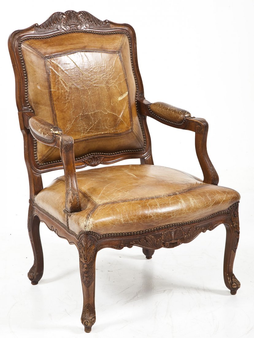 French Fauteil Retailed by William Switzer: DESCRIPTION: A leather backed and seated French fauteil arm chair carved in Spain, upholstered in Vancouver (BC) and retailed by William Switzer (and all so marked on labels). The Duke of Alba form co