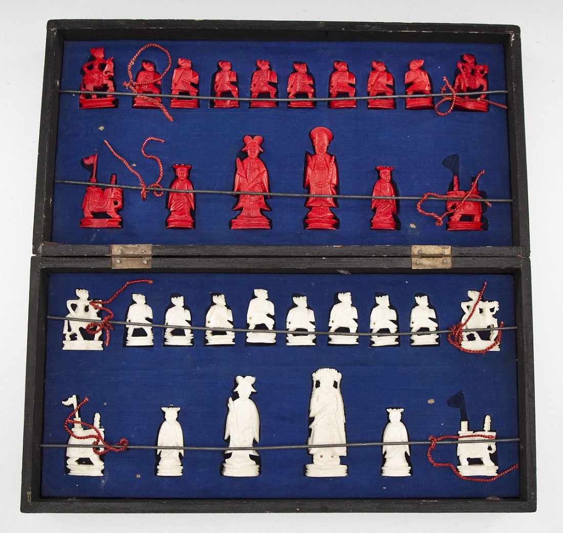 Chinese Ivory Chess Set: DESCRIPTION: Chinese chess set with plain and red dyed carved ivory figures housed in a chess board case with fitted interior. PROVENANCE: Asian circa 1950, purchased by the consignor in Southeast Asi