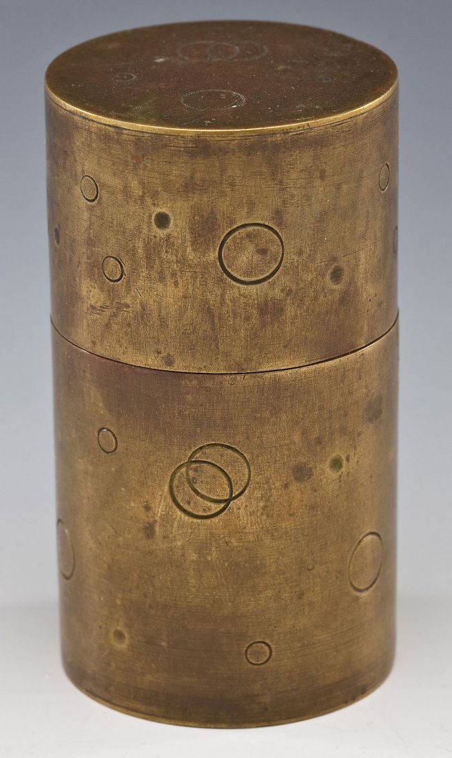 Hayno Focken Small Brass Canister: DESCRIPTION: Small brass canister by Hayno Focken decorated with embossed circles and punches overall. Marked under base "Made in Germany 552" with Focken trademark. MEASUREMENTS: 2" diameter x 3-1/2"