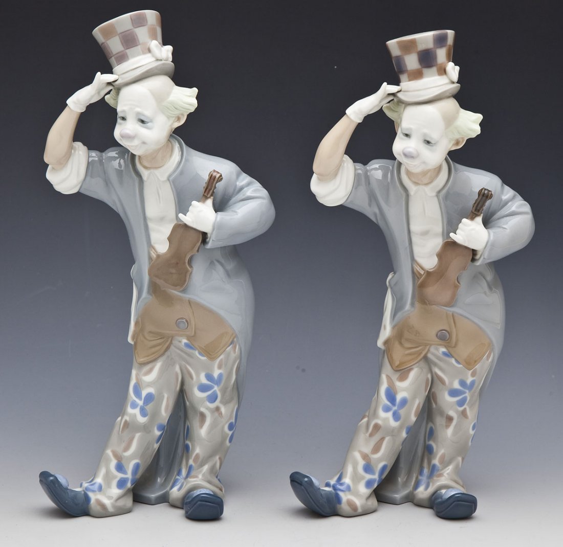 Pair of Lladro Clowns with Violins #1126: DESCRIPTION: Pair of Lladro Clown with Violin figures. Each with top hat, jacket, and flower printed pants. Number 1126. Issued in 1971. Retired in 1986. Marked underneath for Lladro. MEASUREMENTS: Ea