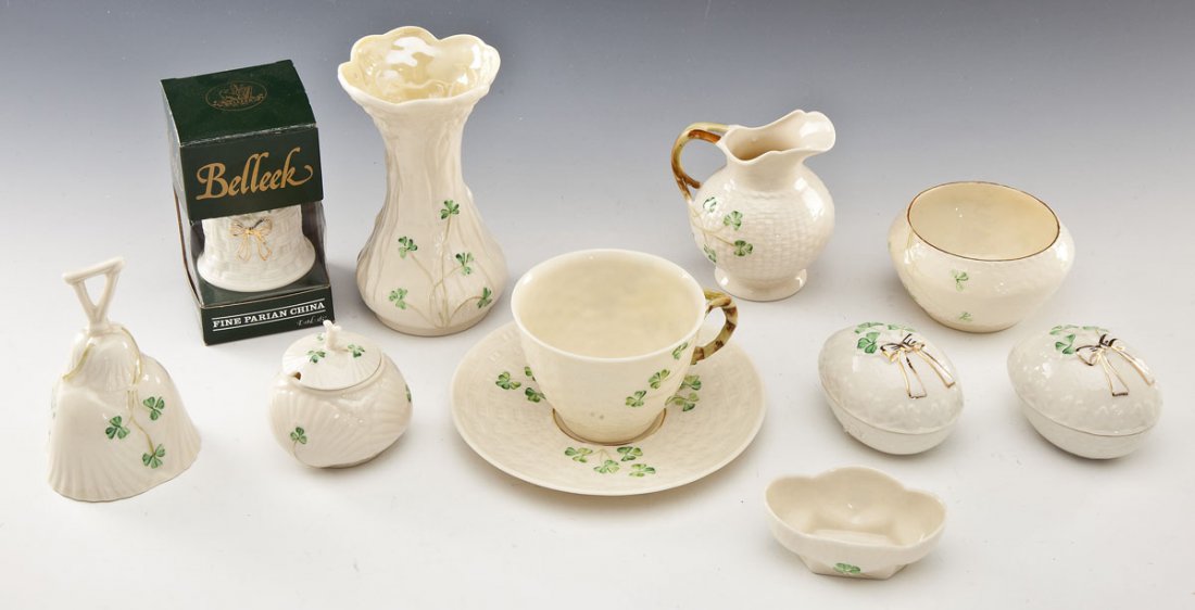 11 Pc Belleek Shamrock: DESCRIPTION: Eleven pieces of Belleek porcelain. Shamrock pattern. Includes: 1) Pair of egg boxes with gilt ribbons on the lid. Each with eighth mark. Each 2-1/2" high. 2) Cup and saucer set. Each wit