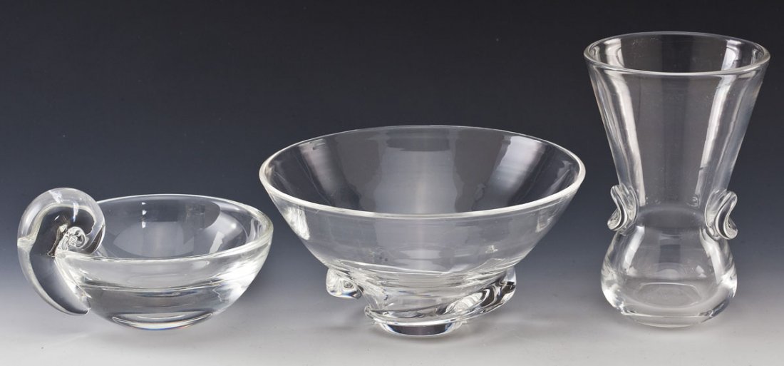 3 Pcs Steuben Glass: DESCRIPTION: Three pieces of Steuben glass. Includes: 1) Clear pinched vase. Signed "Steuben". 6" high. 2) Steuben glass olive dish originally designed by John Dreeves in 1939. Round bowl with scroll 