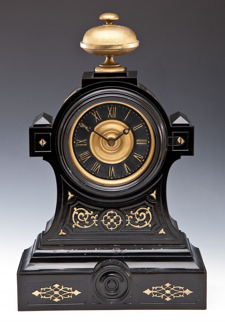 Attrib. to Seth Thomas Metal Mantle Clock: DESCRIPTION: Attributed to Seth Thomas metal mantle clock. Black enamel surface with gold painted details. Black and gold face with Roman numerals. Bell shaped finial. With pendulum and key. MEASUREME