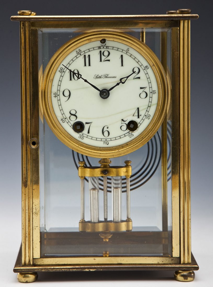 Seth Thomas Crystal Regulator: DESCRIPTION: Seth Thomas crystal regulator. White face with black numbers. Movement marked on back with Seth Thomas mark and "48N". With key and pendulum. MEASUREMENTS: 6-1/2" x 4-3/4" x 9-3/8" high. 