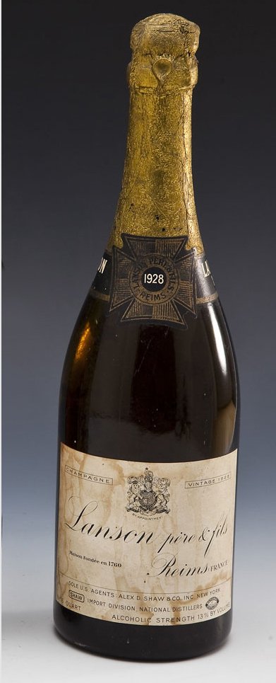 Lanson Pere & Fils Vintage 1928 Champagne: DESCRIPTION: Lanson Pere & Fils Vintage 1928 Champagne from Reims, France. MEASUREMENTS: One quart. CONDITION: Heavy sedimentation. Water damage and fading to the labels. Losses to foil around neck.